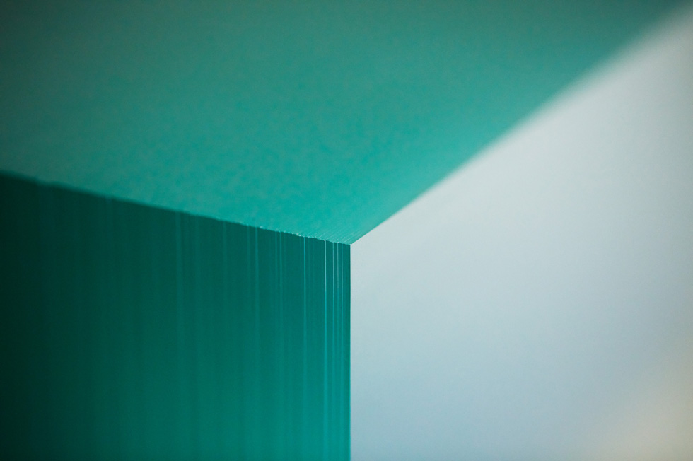 Close-up of glass plates converging to form a corner.