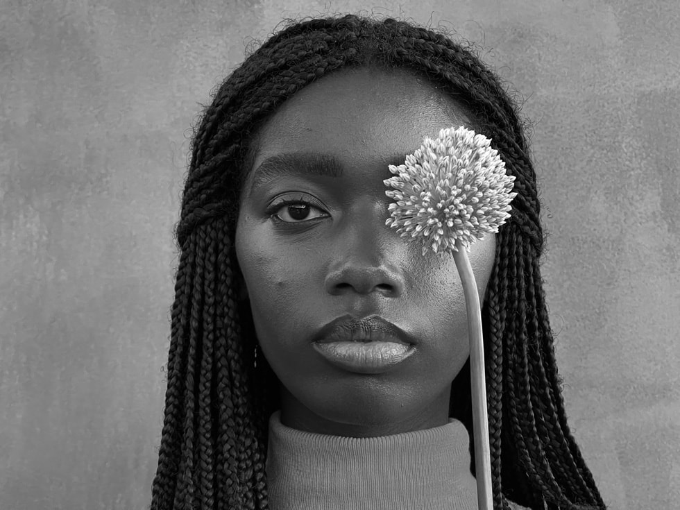 Black and white portrait of a woman taken on iPhone 13 Pro’s Telephoto camera.