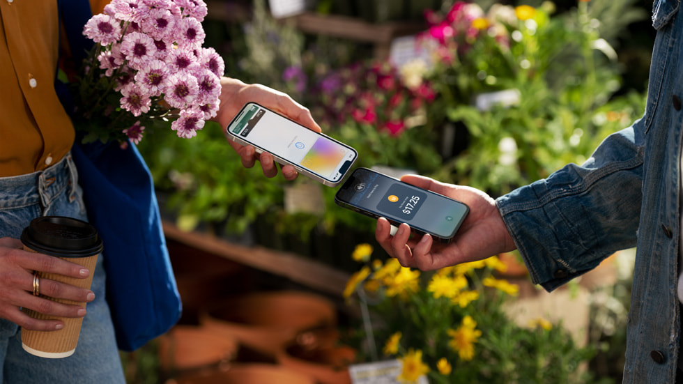 A person using Tap to Pay on iPhone to make a payment to another iPhone user.