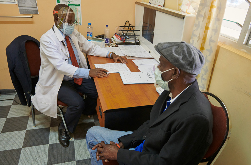 Hospital clinician Samson Tembo interviewing patient Wilson Kalunga in Zambia.