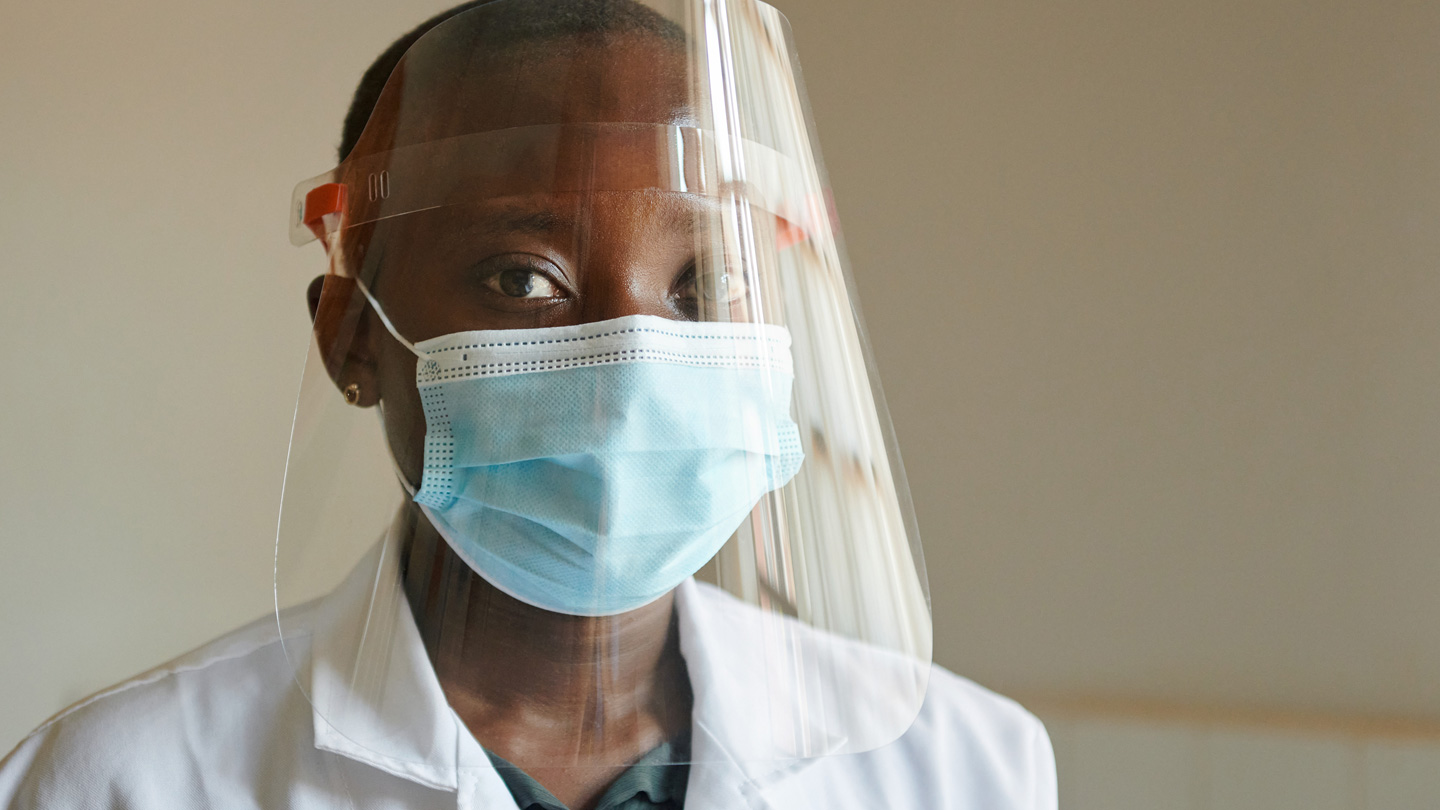 A healthcare worker in Zambia wearing a face shield and mask.