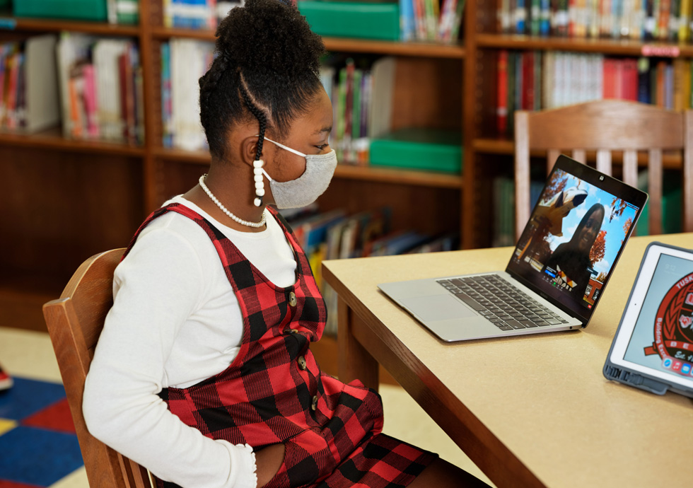 Katilynn Calhoun uses MacBook Air to interview Reveign Lee.