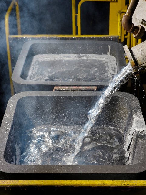 Molten aluminum flows into a container.