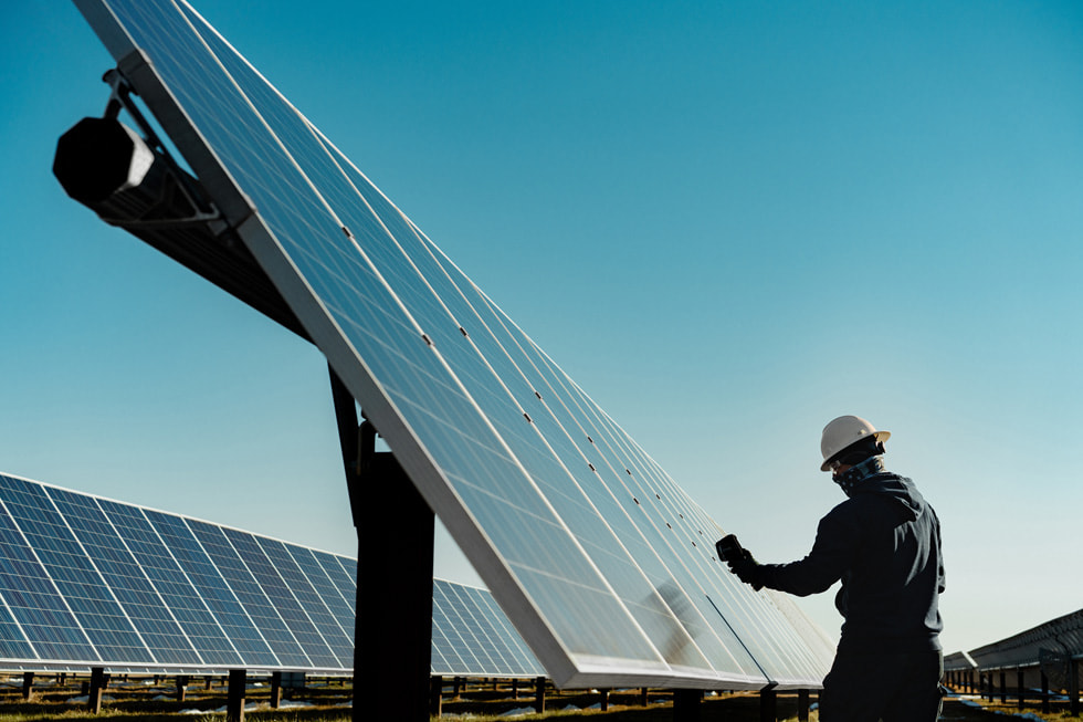 An employee works on the roof of the Duke Energy Sustainable Solutions solar installation.