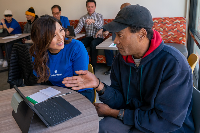 An Apple volunteer and attendees of a Day of Service event with Destination: Home.