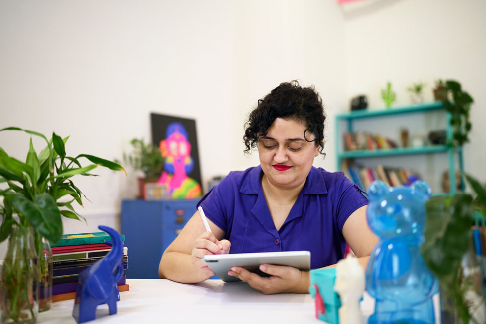 Mira Felicia Malhotra using iPad Pro at her desk.