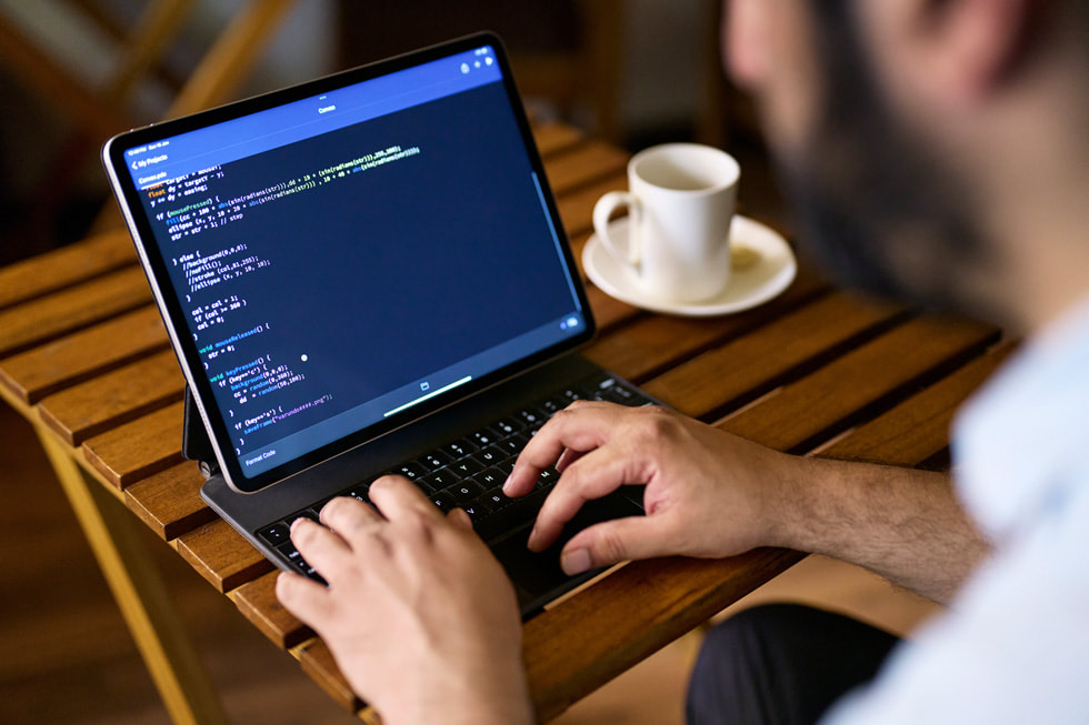 Varun Desai using iPad Pro with Magic Keyboard for coding.