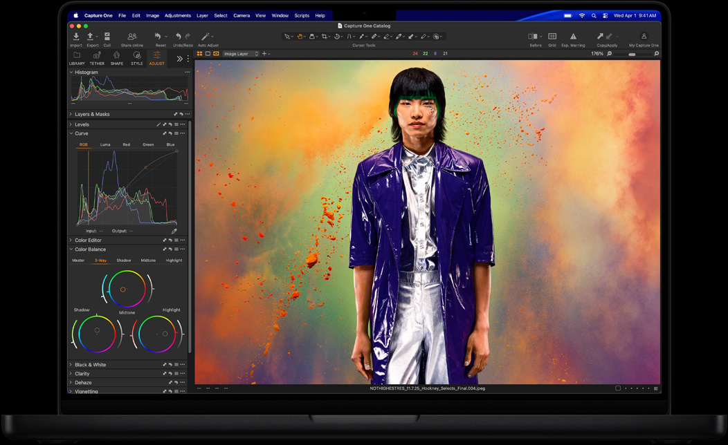 MacBook Pro screen of a photo of a person being edited in Capture One