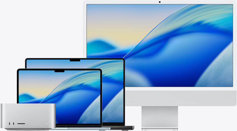The macOS Tahoe wallpaper across family of Mac models from left to right: Mac Studio, 13-in MacBook Air in Sky Blue, 14-in MacBook Pro in Space Black and 24-in iMac in Silver