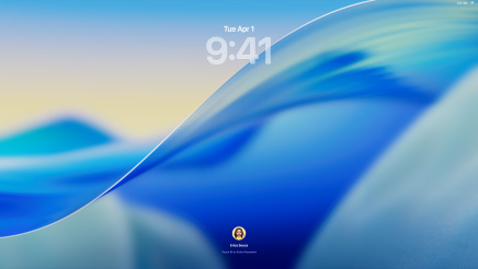 Three Mac models facing forwards, 16-inch MacBook Pro in Silver at left with Phone app on screen showing recent contacts, 24‑inch iMac in Blue in centre, macOS Tahoe wallpaper on screen, and 13-inch MacBook Air in Midnight at right, screen shows Spotlight Search over the desktop with Liquid Glass versions of the Dock and various widgets such as Calendar, Clock and Weather