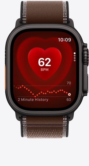 Apple Watch Ultra 4, screen shows Heart Rate app, current beats per minute, titanium case, black color, connected to Trail Loop band, dark umber color (brown)